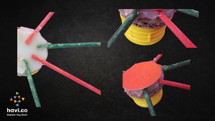 stick the sticks over the cardboard ferris wheel